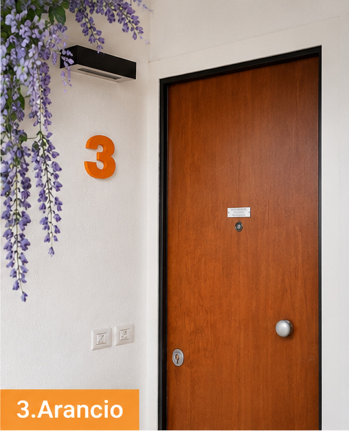 Apartment 3.Arancio — entrance door with the orange number 3 on the wall