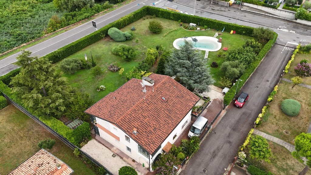 Aerial view of the GioiaSulGarda house with the three apartments, the fenced garden and the natural pool